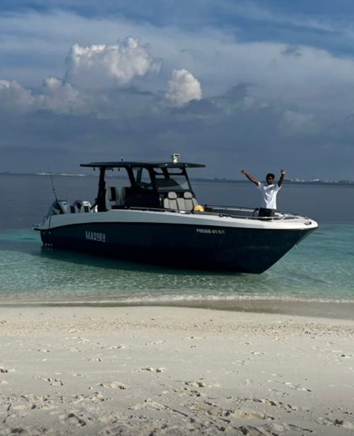 SALTRIPS boat Masoru anchored off a white sand beach